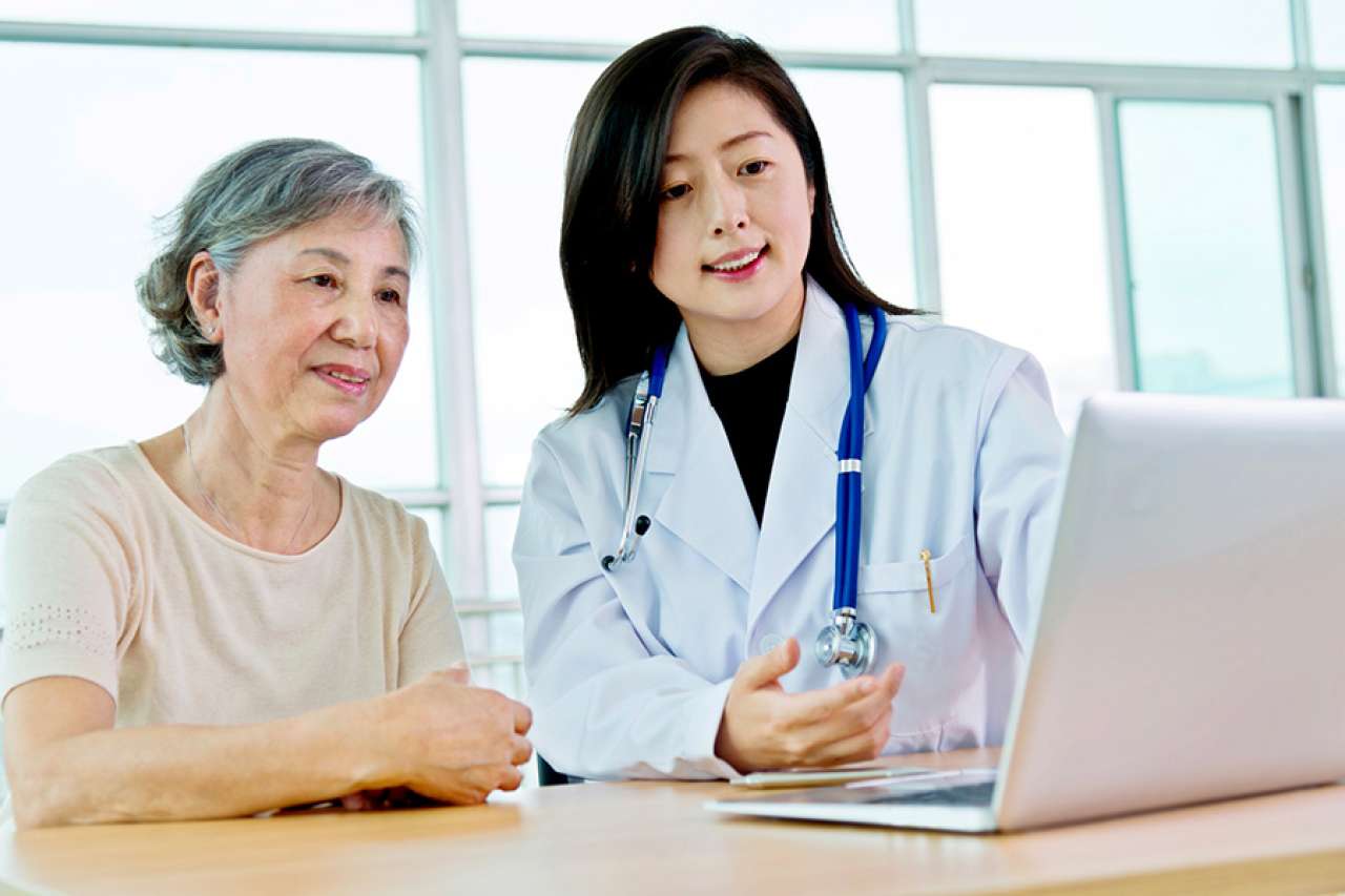 Doctor with patient and laptop