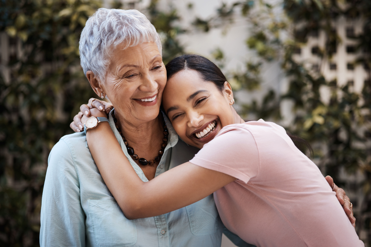 An older woman hugging a younger woman
